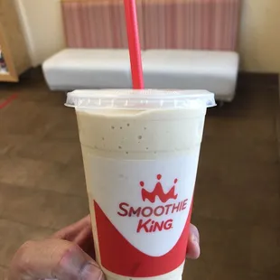 a hand holding a smoothie