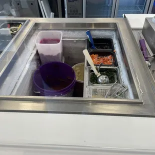 a sink with a variety of food in it