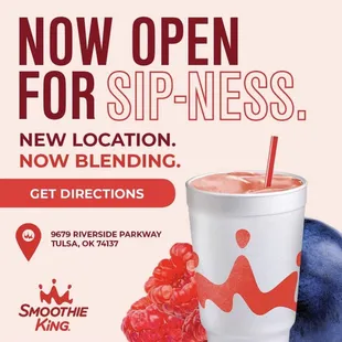 a smoothie with a straw and raspberries