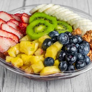 Açaí bowl topped with granola, banana, pineapple, kiwi and blueberries