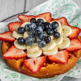 Protein vegan waffle topped with fresh strawberries, blueberries, and banana