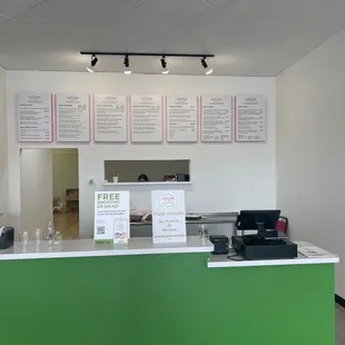 a counter with menus on the wall