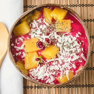 a bowl of smoothie with oranges and coconut