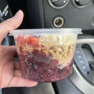 Açaí bowl with bananas, strawberries, blueberries, granola, and coconut flakes