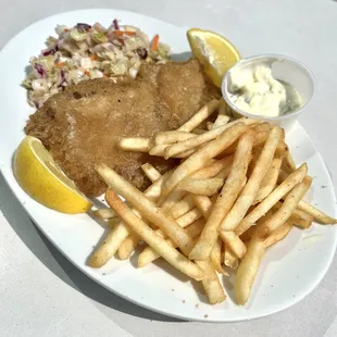 Fish and chips with shoestring potatoes, homemade coleslaw and homemade tartar sauce.