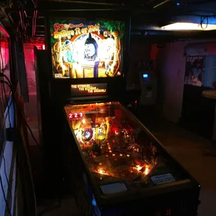 a pinball machine in a dimly lit room