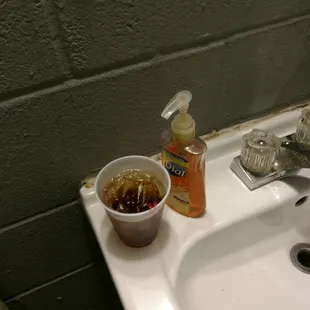 a sink with a bowl of food on it
