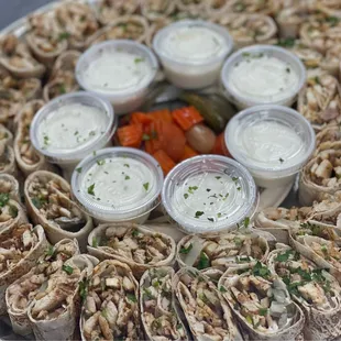 a platter of wraps and dips