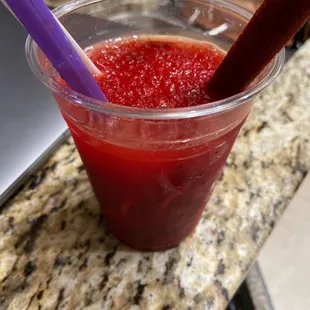 a plastic cup with a straw and a purple straw