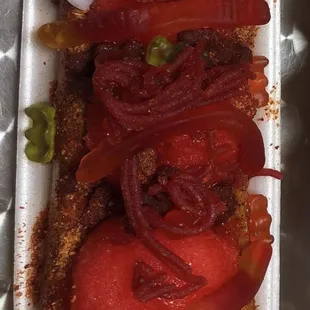 Watermelon Sorbet (3 scoops), with Skwinkles candy, gummies, tamarind candy, with chamoy on bottom.