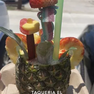 a pineapple with strawberries and strawberries