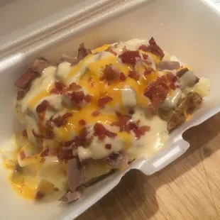 Brisket Texas Tater with butter, queso, cheddar, &amp; bacon bits it's the Bomb!