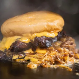 a hamburger with meat and cheese