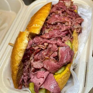 a roast beef sandwich in a styrofoam container
