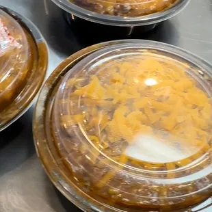 three trays of food sitting on a table