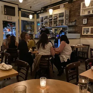 people sitting at tables in a restaurant