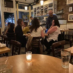 people sitting at tables in a restaurant