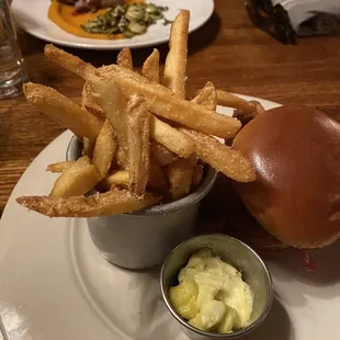 Fries with chicken sandwich in the foreground - duck entree in the background