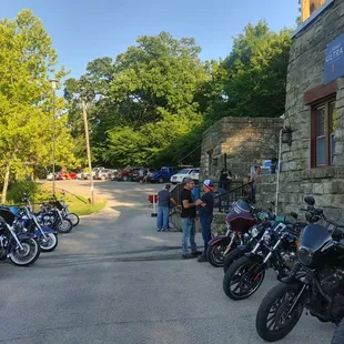 a line of motorcycles parked in front of a restaurant