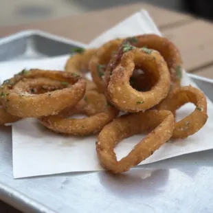 a pile of onion rings on a tray