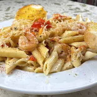 Seafood Pasta. Grilled shrimp, crawfish, red pepper, cajun seasoning with creamy alfredo sauce