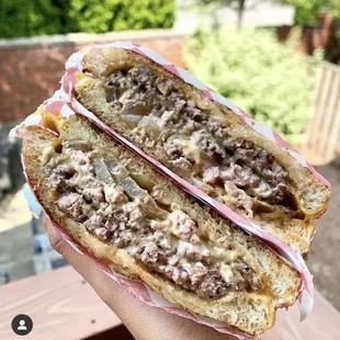 a person holding a sandwich