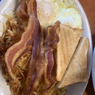 Two eggs over medium. Crispy Hashbrowns and crispy bacon.