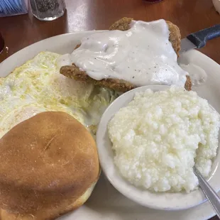 Chicken fried steak, grits, biscuit, eggs