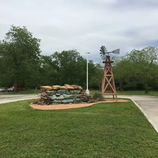 a windmill in a grassy area