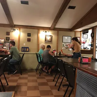 people sitting at tables in a restaurant
