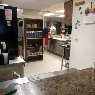 people in a kitchen preparing food