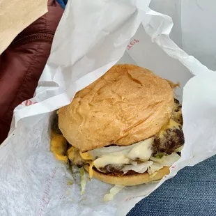 a cheeseburger wrapped in paper