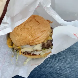 a cheeseburger wrapped in paper