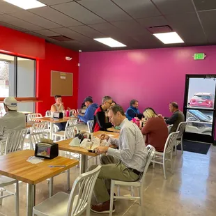 people sitting at tables in a restaurant