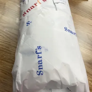 a sandwich wrapped in paper