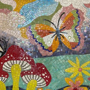 a colorful mosaic with butterflies and flowers