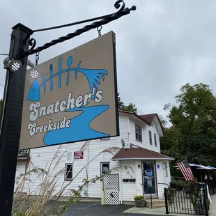 a sign in front of a restaurant