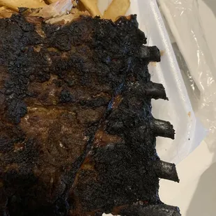 Burned ribs?  How do you allow this to leave the kitchen to go to a customer?