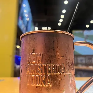 a copper mug with a straw