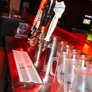 a row of beer glasses on a bar