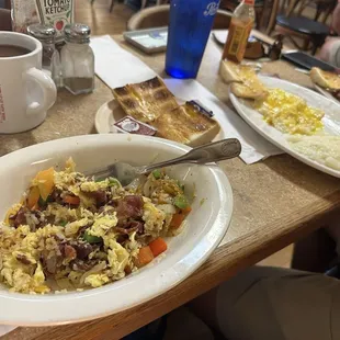 Breakfast bowl = yummy! 2 eggs over medium, cornbeef hash and grits  Toasted Cuban bread