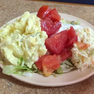 Salad bar: Potato salad, tomatoes with cucumbers and coleslaw