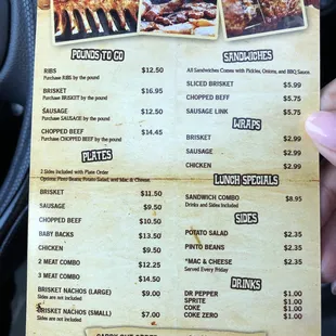 a hand holding a menu