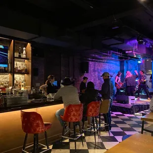 a group of people sitting at a bar