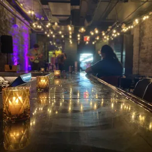 a bar with candles and people in the background