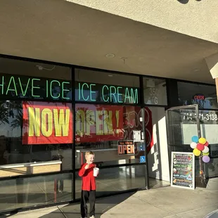 a woman standing outside of a store