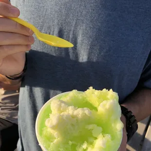 a man holding a bowl of ice cream