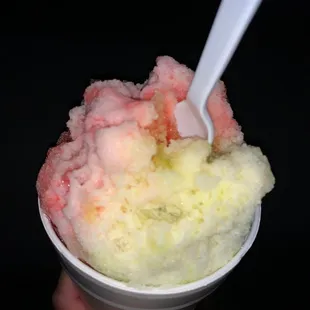 a hand holding a cup of ice cream