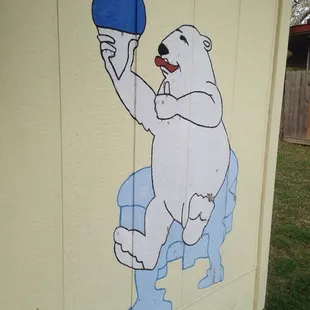 a polar bear holding a ping pong ball