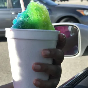 a hand holding a cup of ice cream